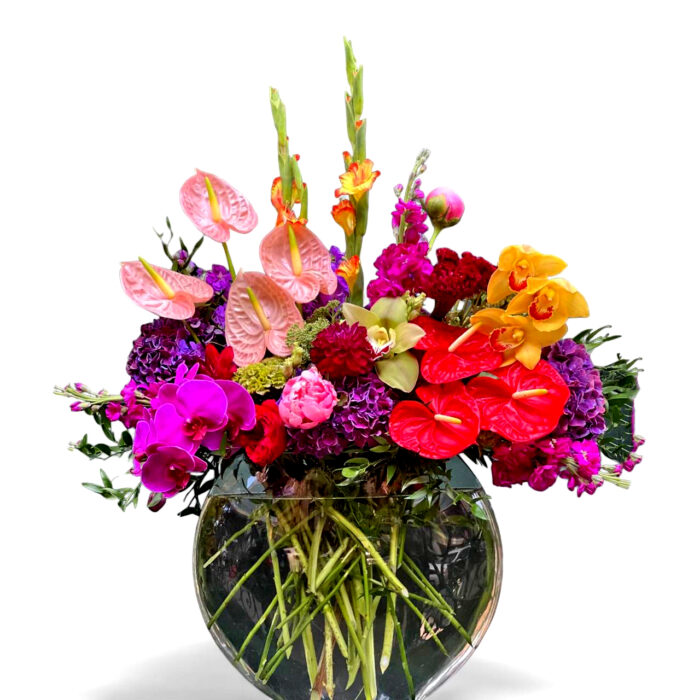 Large modern vase with bright and interesting long lasting flowers like anthurium, cymbidium, dahlia, calla, peony, hundrengia, gladiolus, stock.