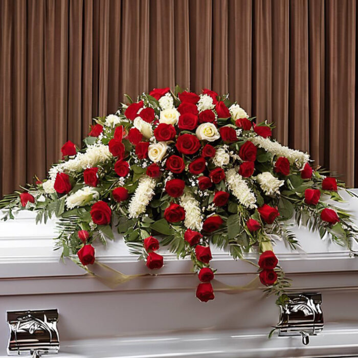 Red roses with the addition of white flowers casket Spray