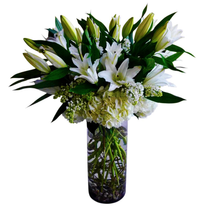 White hydrangea and lilies in tall vase.