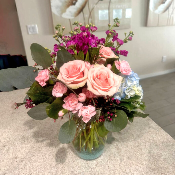 A stunning and elegant floral arrangement featuring lush roses,